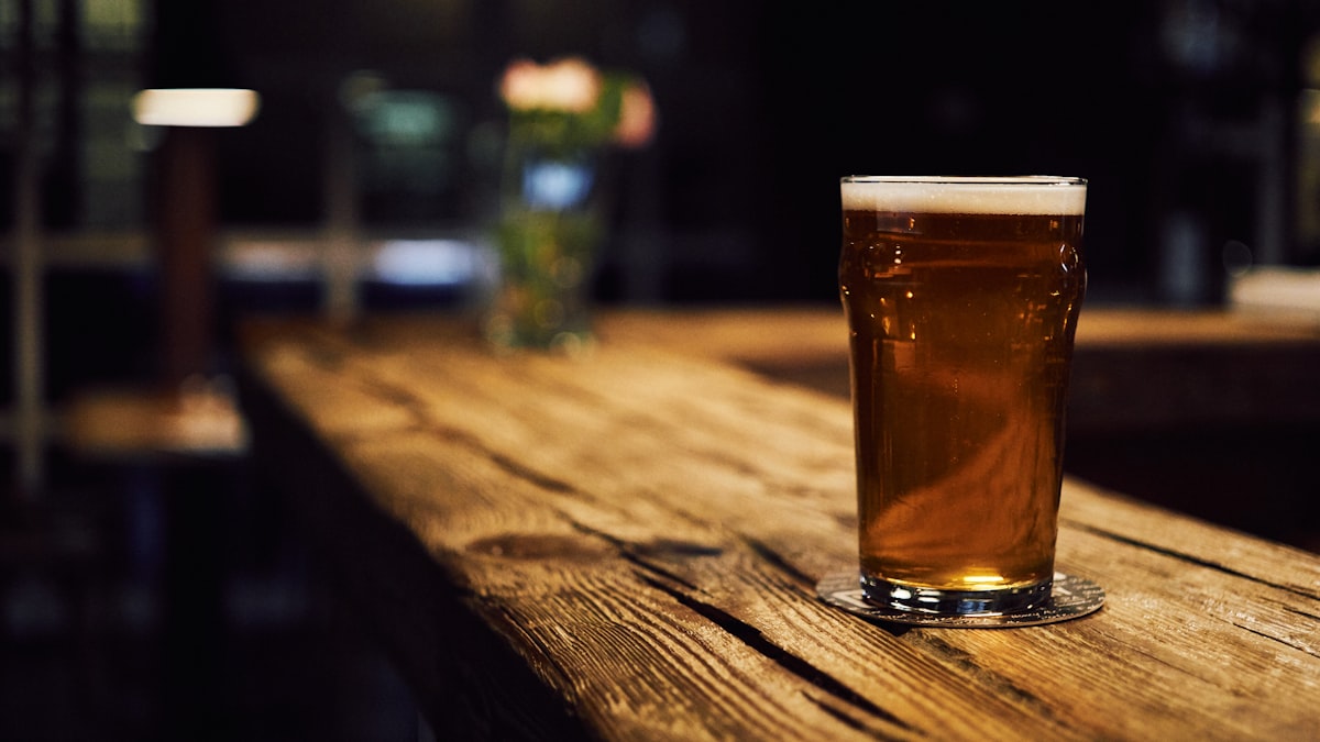 Amber draft beer on a worn wood bar